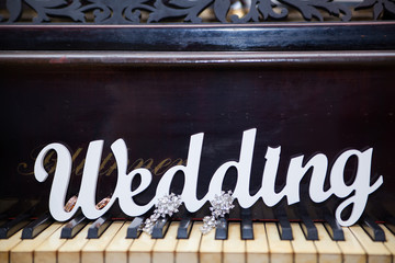 The word Wedding on the piano