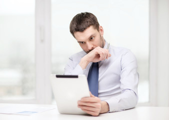 stressed businessman with tablet pc and documents