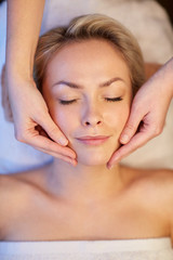 Fototapeta na wymiar close up of woman having face massage in spa