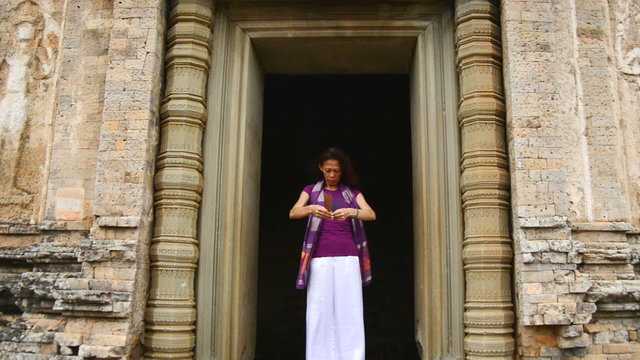 Female Buddhist Praying with Incense in Temple Doorway -   Angkor Wat Temple Cambodia
