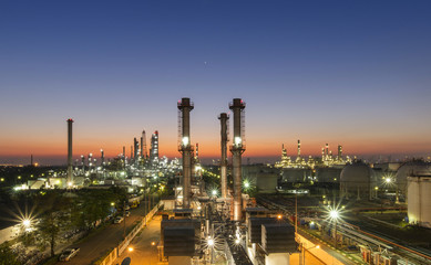 Fototapeta na wymiar Oil refinery plant at sunset, The night view of petroleum and petrochemical factory with distillation column, drum and pipeline. Gas, diesel and chemical business industry is important for economy.