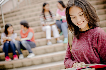 group of happy teen high school students outdoors