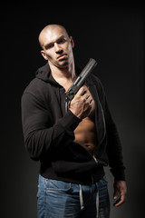 male gangster holding a gun isolated on dark background
