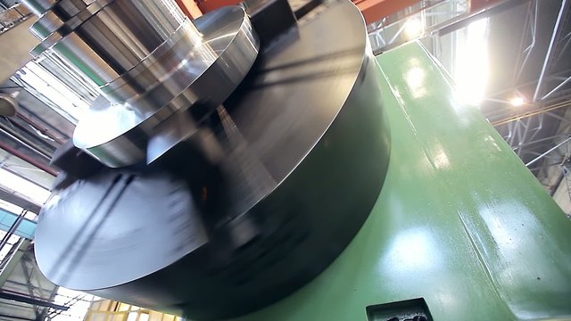 A large spindle lathe is rotating at an industrial plant