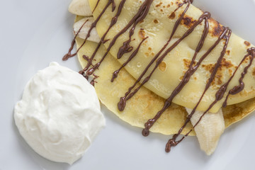 crepe with banana and chocolate sauce