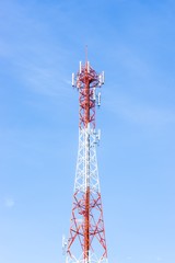 Red and white antenna on blue sky