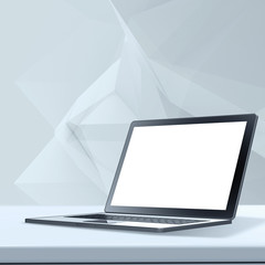 Laptop with blank screen on laminate table and low poly geometri
