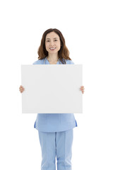 Naklejka premium Female doctor or nurse showing a blank poster