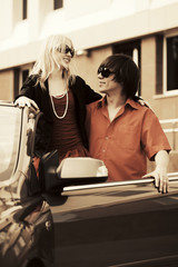 Happy young couple in a convertible car
