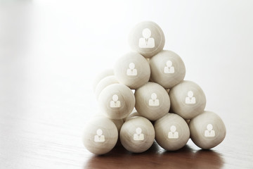 Leadership business concept,people icons on wooden balls on lapt