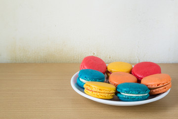 French macaroons on plate, with vintage pastel filtered