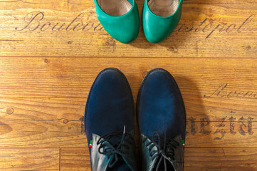 Man and woman leather shoes view from above wood floor