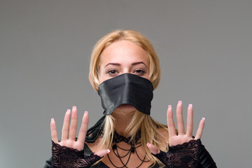 Woman with self-adhesive tape over her mouth