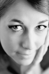 Fototapeta premium Black and white closeup portrait of a beautiful young woman
