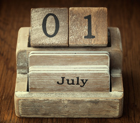 A very old wooden vintage calendar showing the date 1st July on