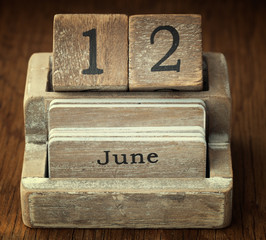 A very old wooden vintage calendar showing the date 12th June on