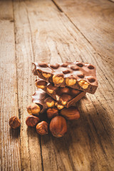 Chocolate and nuts on a wooden table in vintage style