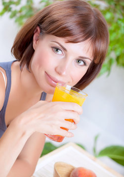 Beautiful woman drinking juice