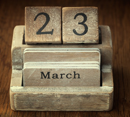 A very old wooden vintage calendar showing the date 23rd  March