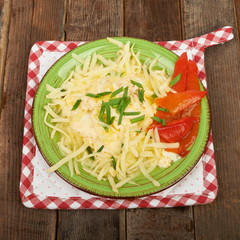 Scrambled eggs with cheese and herbs on the table, picnic