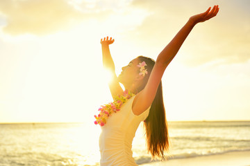 Happy carefree woman free in Hawaii beach sunset