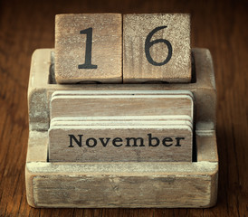 A very old wooden vintage calendar showing the date of 16th Nove