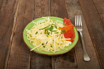 Scrambled eggs with cheese and herbs on the table, picnic