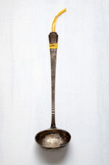 Old vintage metal soup ladle on a table