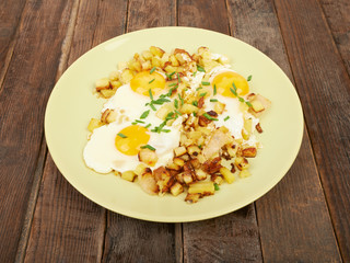 Fried potatoes with eggs on the table
