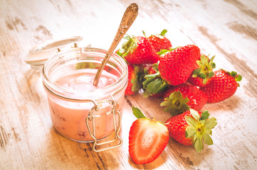 Spring fruits, strawberries with strawberry yogurt on a vintage