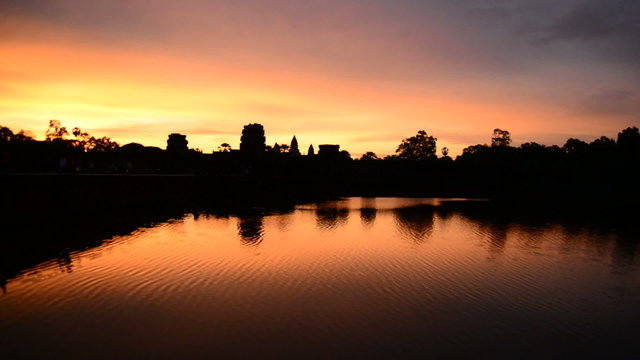 Zoom out - Silhouette of the Main Temple Buildings with Lake Reflection at Sunrise - Angkor Wat, Cambodia