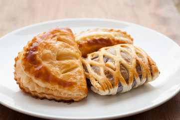homemade fresh fruit pies on white dish