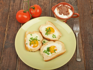 Fototapeta na wymiar Fried eggs in a plate on the table