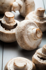 White button mushrooms on a wooden blue table