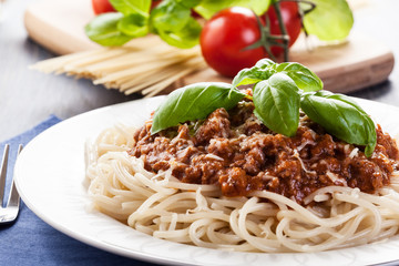 Spaghetti bolognese with cheese and basil