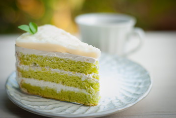 Delicious of Green tea mousse cake on wooden table