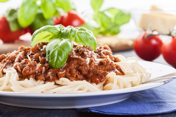 Spaghetti bolognese with cheese and basil