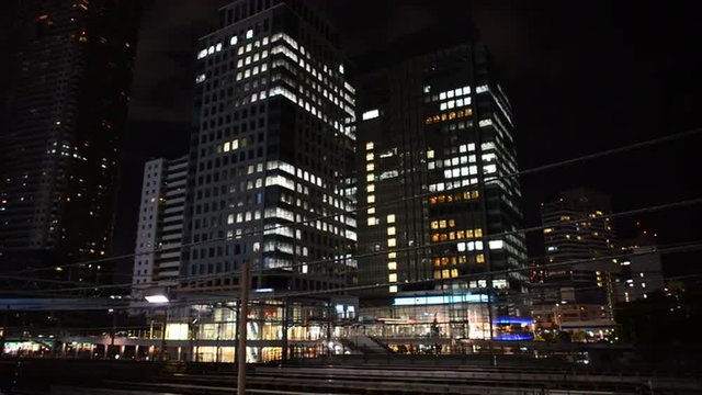 Time Lapse of Train Passing over Bridge in Central Tokyo Japan at Night