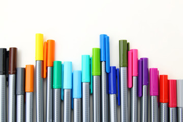 Colorful markers on a white background