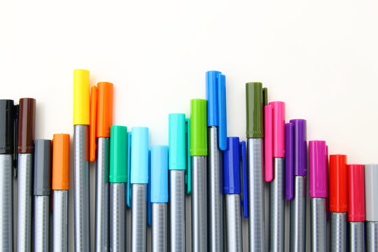 Colorful markers on a white background