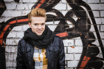 Fashion male portrait on graffiti wall