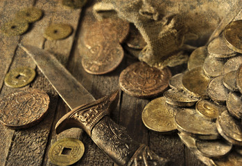 Still life with ancient coins, dagger and grunge texture effect