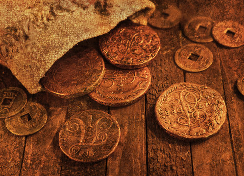 Ancient coins on wooden background with texture effect