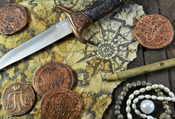 Pirate still life with dagger, coins and map