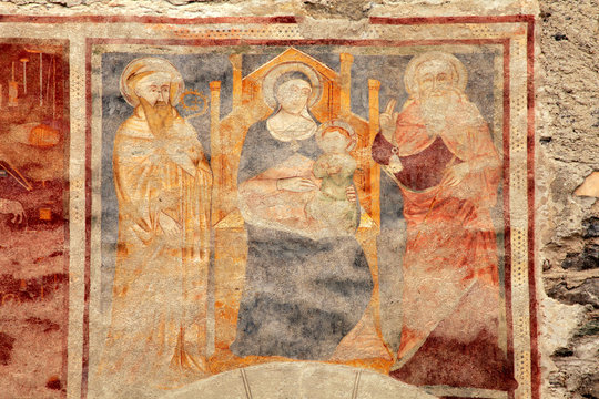 Religion medieval fresco on the church wall in Bormio, Italy