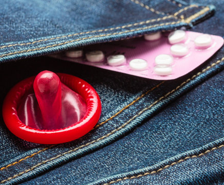Pills and condom in denim pocket.