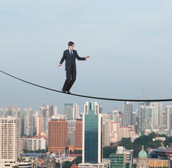 Fototapeta na wymiar businessman walking on a rope