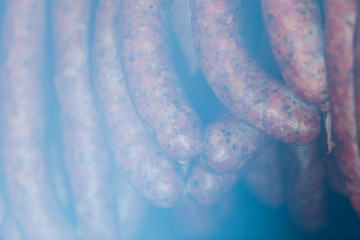 Traditional food. Smoked sausuages in smokehouse.