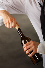 Man opening bottle of wine