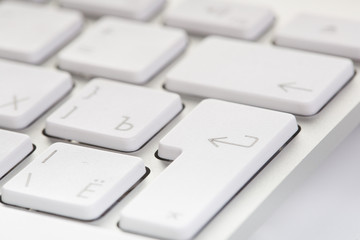 White computer keyboard close-up. Focused on 'Enter' key